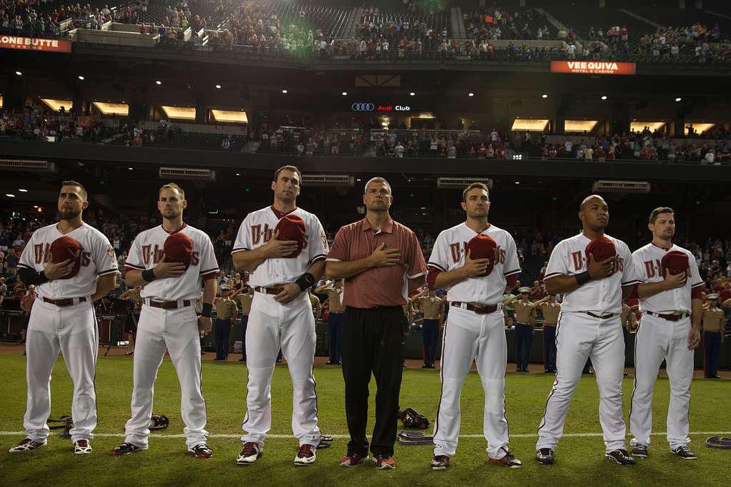 Diamondbacks Players at Chase Field – Stadium Funding Debate Arizona Diamondbacks players stand on the field with their hands over their hearts during the national anthem at Chase Field.